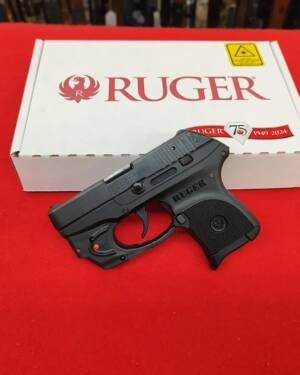 Ruger LCP 380 Pistol with Viridian E-Series red laser in front of factory box