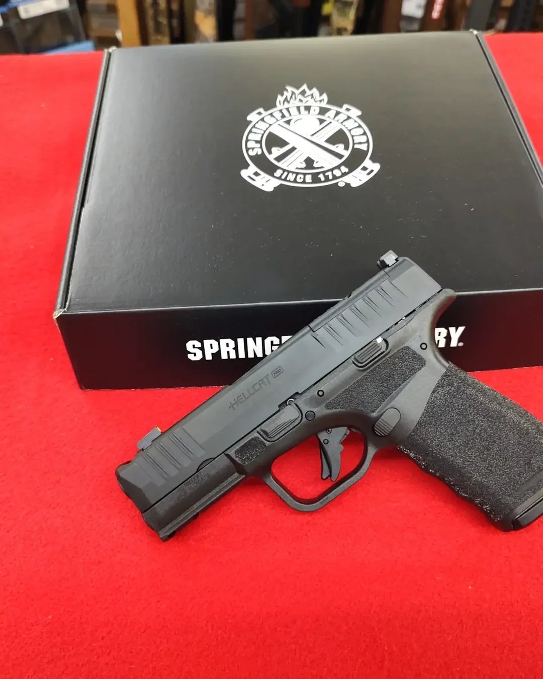Springfield Armory Hellcat Pro Comp OSP 9mm handgun resting on factory box