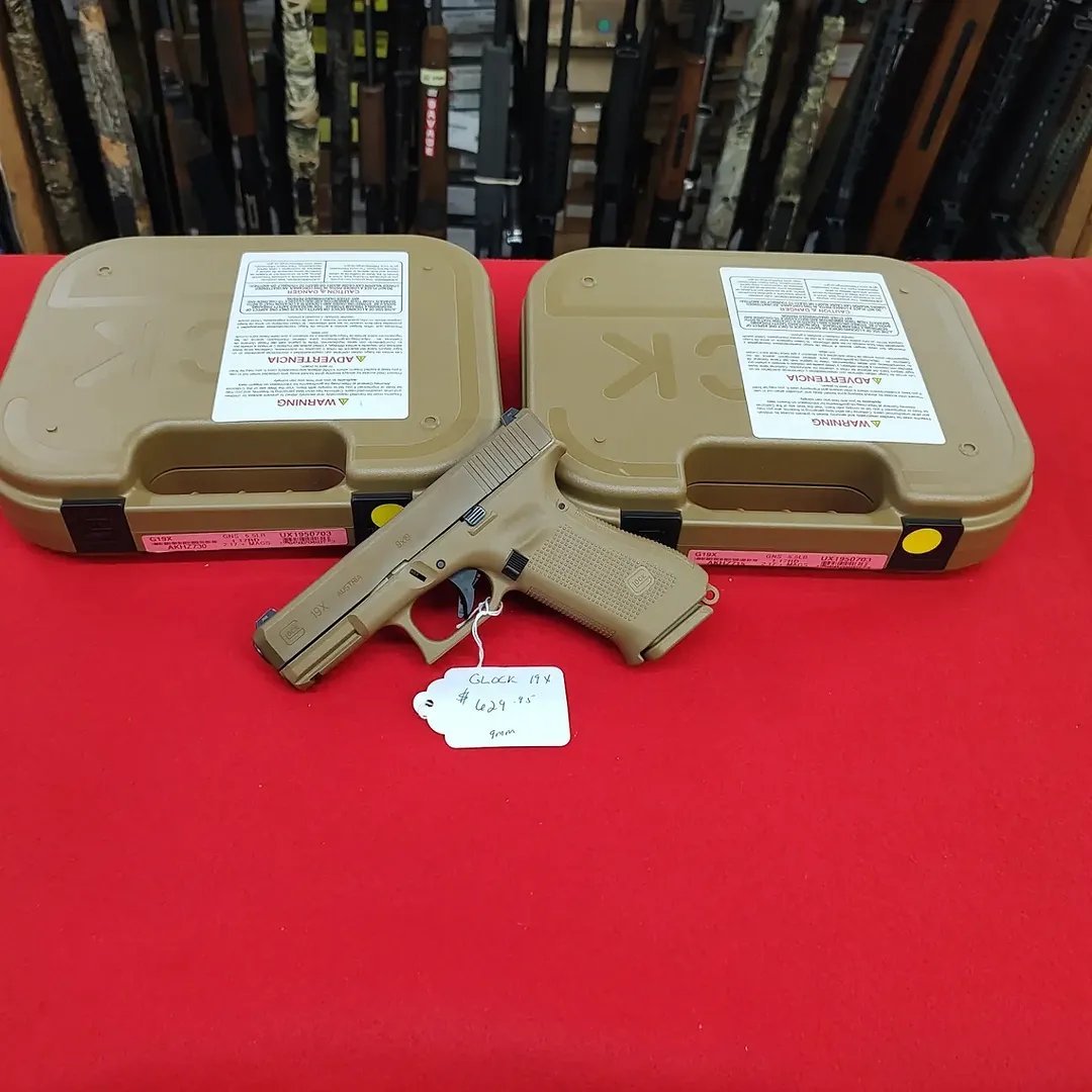 Glock 19X Coyote Pistol 9mm handgun resting in front of matching coyote hard cases