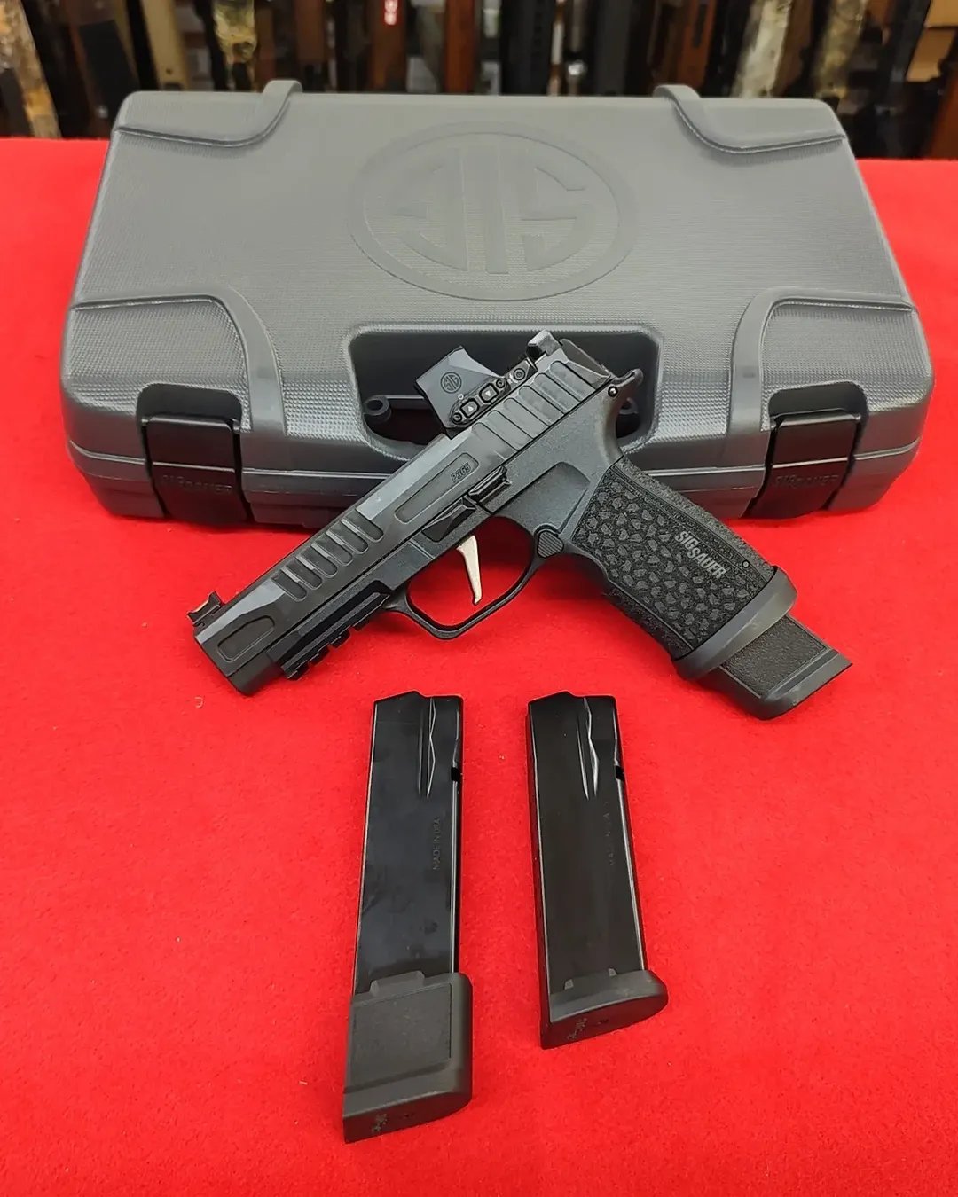 Sig P365 Fuse online 9mm pistol with Romeo-X optic and magazines resting in front of hard case near me