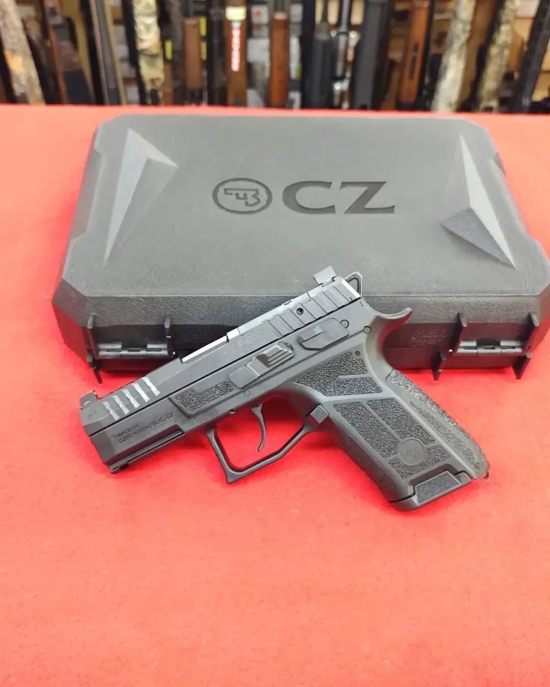 CZ P-09 C Nocturne 9mm compact pistol resting in front of black factory hard case near me