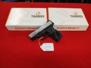 Taurus G2C 9mm stainless slide pistol with price tag on red display background near me